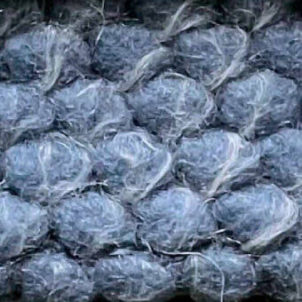 Textured plastic material, grayish-blue “puffo” color, displays rounded cellular forms with translucent, fibrous surface and irregular crinkled pattern.